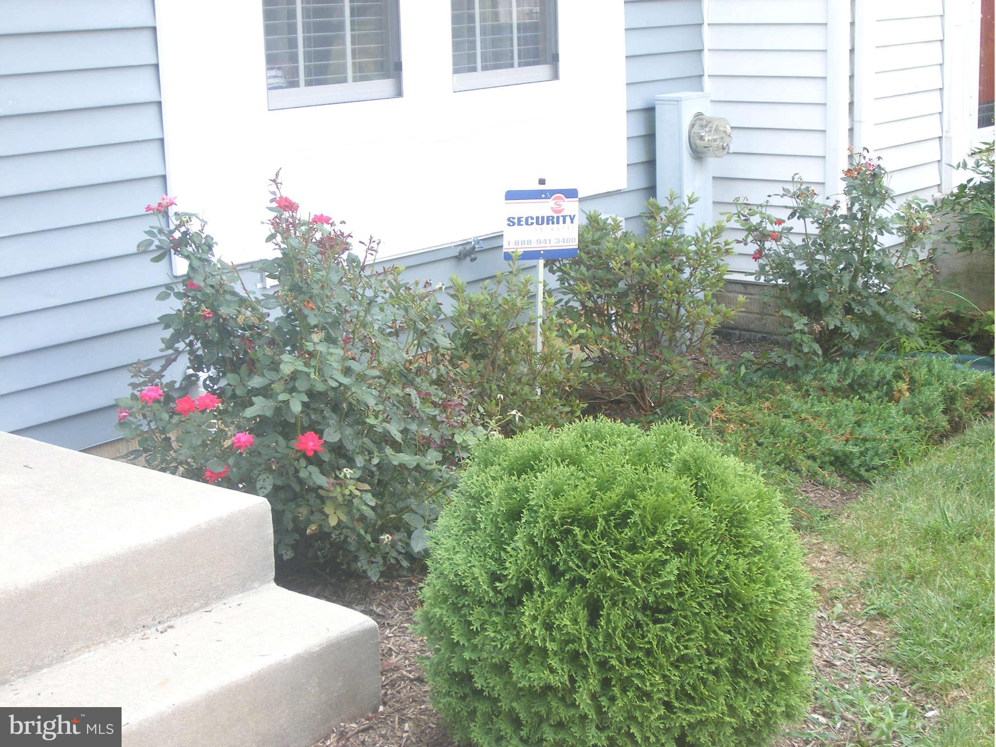 7785 Paddock Way Baltimore, MD 21244 - Photo 7 of 30 a flower garden in front of a house