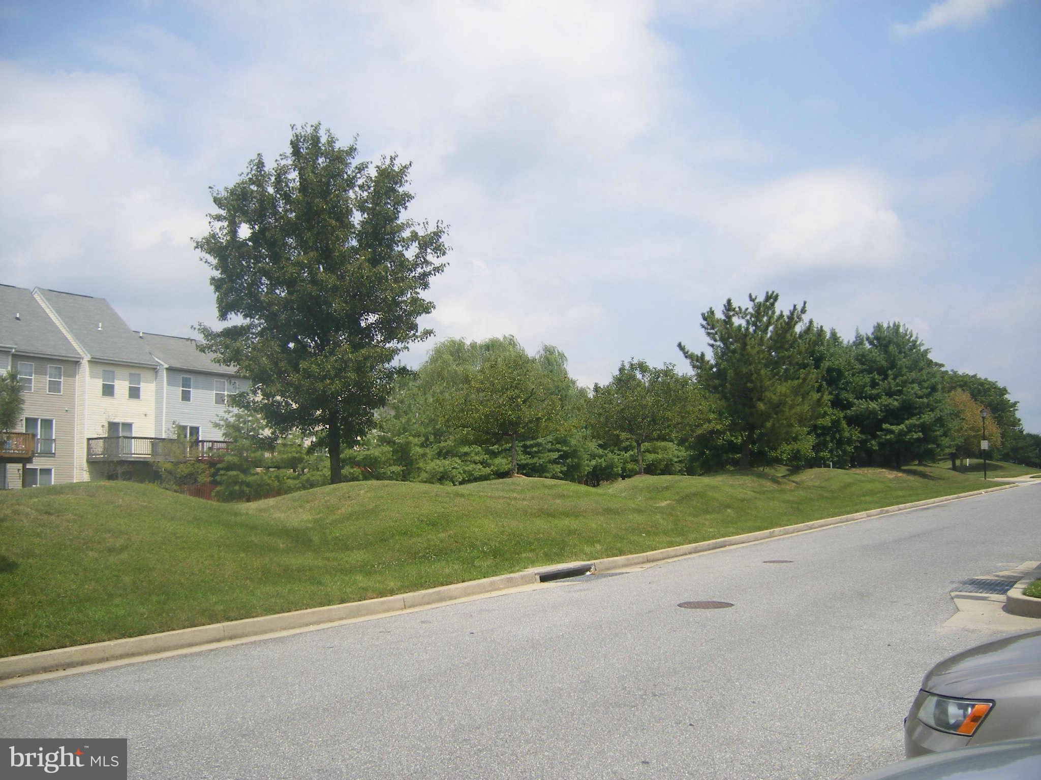 7785 Paddock Way Baltimore, MD 21244 - Photo 9 of 30 a view of a grassy field with trees in the background