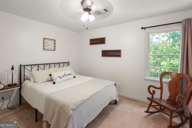 a bedroom with a bed and a window