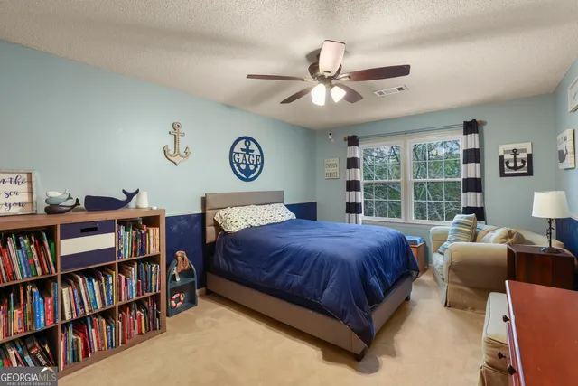 a bedroom with a bed furniture and a book shelf