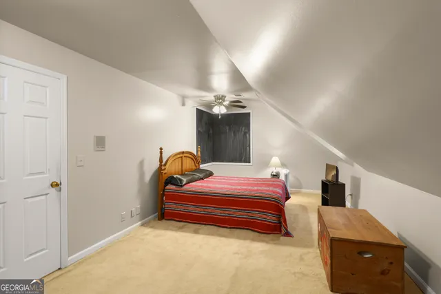 a bedroom with a bed and lamp