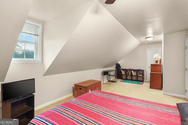 a bed room with a bed and a television