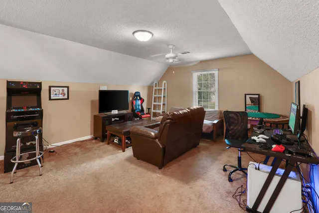 a living room with furniture a flat screen tv and a window