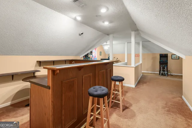 a kitchen with stainless steel appliances granite countertop a sink a stove and a refrigerator