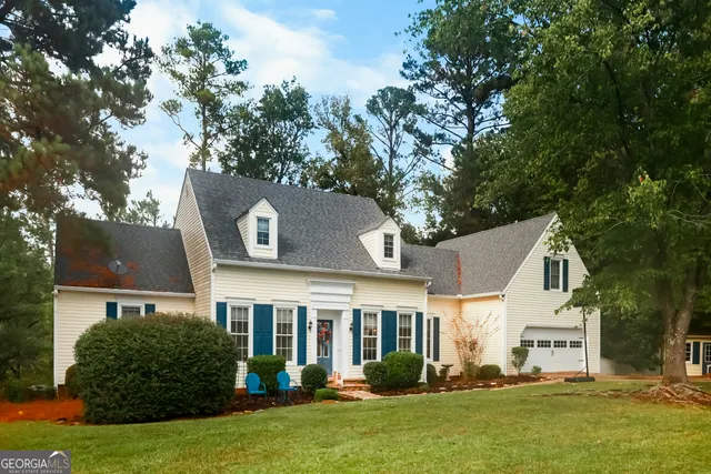 a front view of a house with a garden and plants