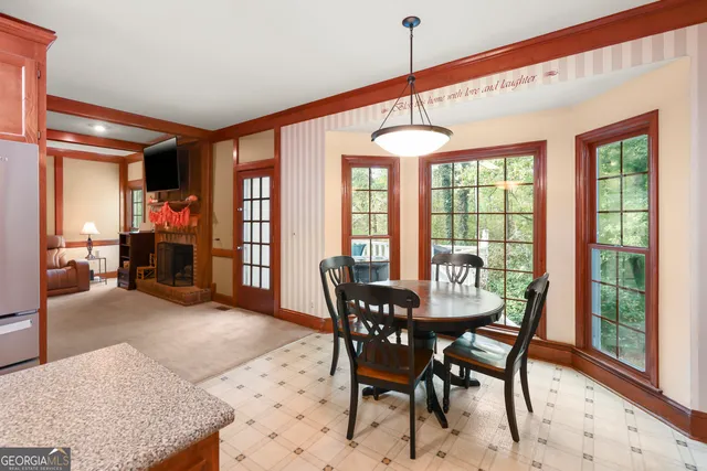 a dining room with furniture window and outside view