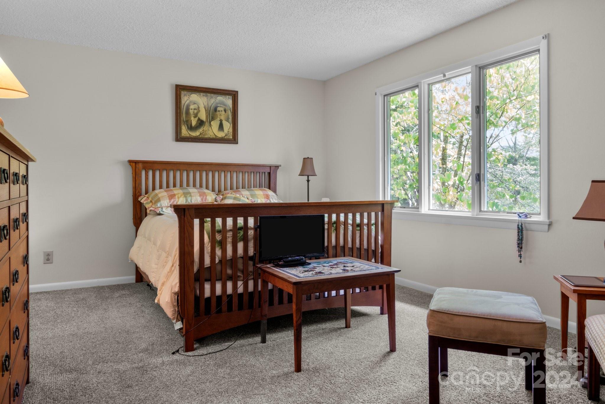 103 Crowfields Drive Asheville, NC 28803 - Photo 15 of 29 a bedroom with a bed and a window