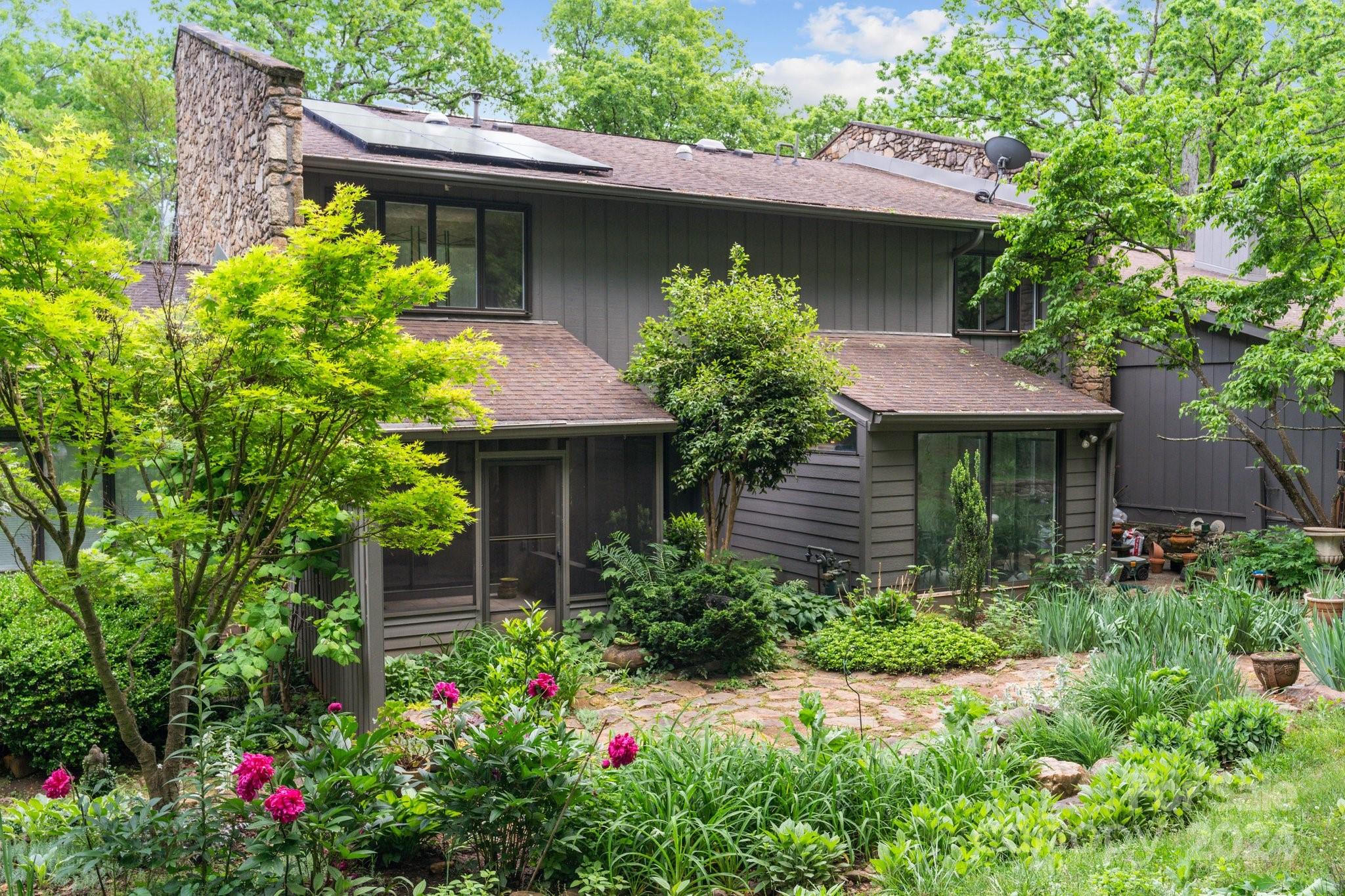 103 Crowfields Drive Asheville, NC 28803 - Photo 20 of 29 a view of a garden with a fountain
