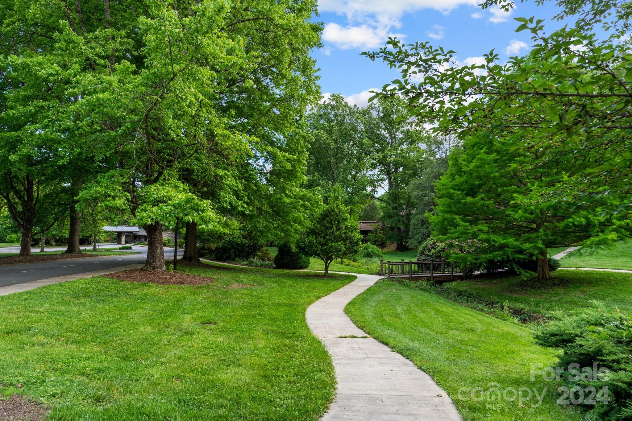 103 Crowfields Drive Asheville, NC 28803 - Photo 22 of 29 a view of a garden with a tree