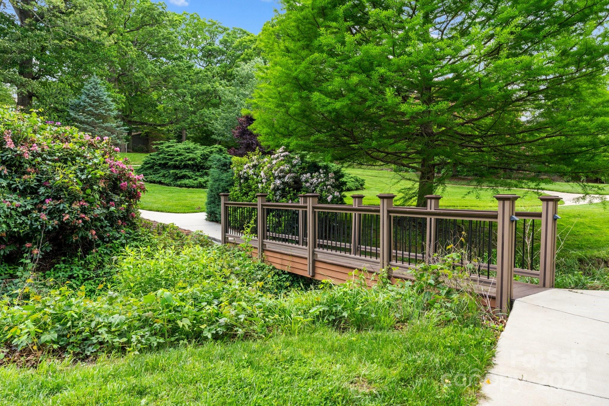 103 Crowfields Drive Asheville, NC 28803 - Photo 23 of 29 a view of a backyard with plants and garden