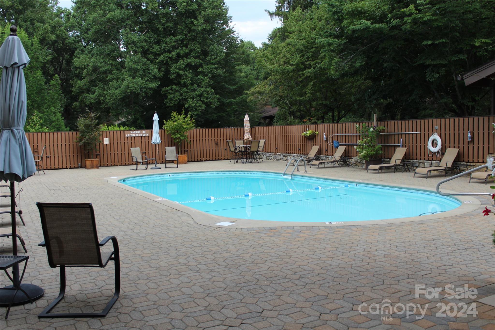 103 Crowfields Drive Asheville, NC 28803 - Photo 26 of 29 a view of a swimming pool with a patio and fire pit