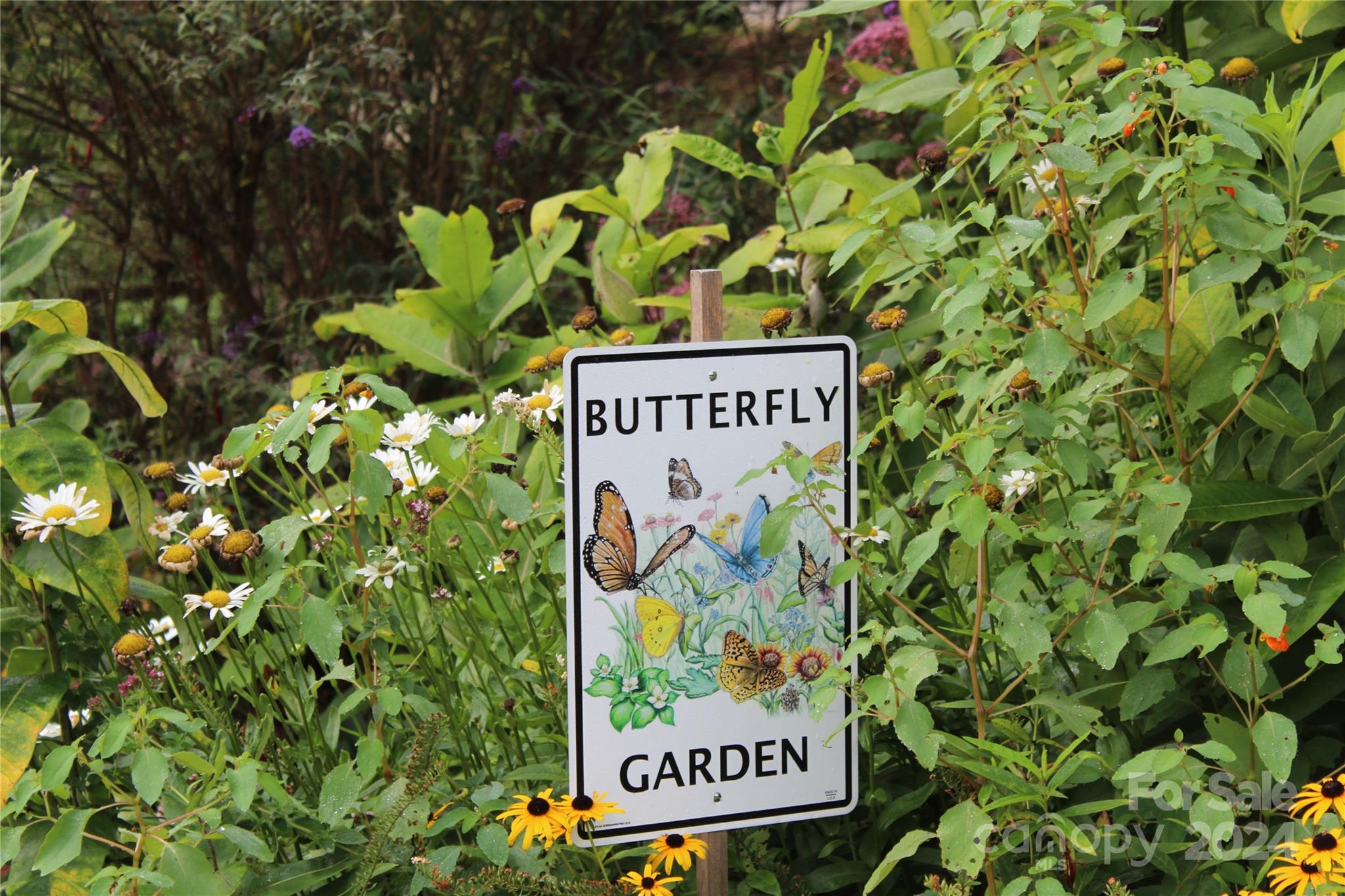 103 Crowfields Drive Asheville, NC 28803 - Photo 28 of 29 a sign that is sitting in front of flowers