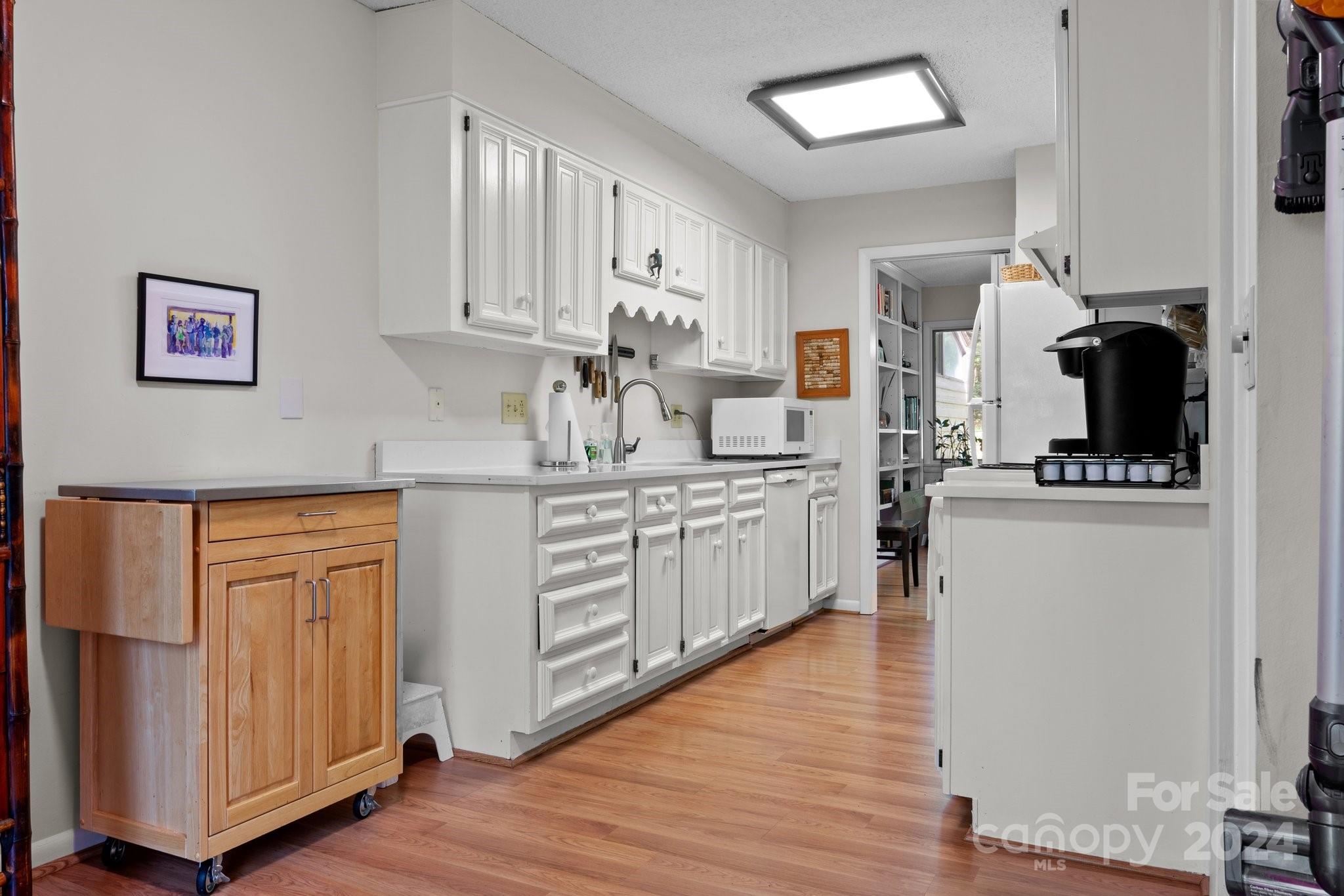 103 Crowfields Drive Asheville, NC 28803 - Photo 6 of 29 a kitchen with white cabinets and appliances