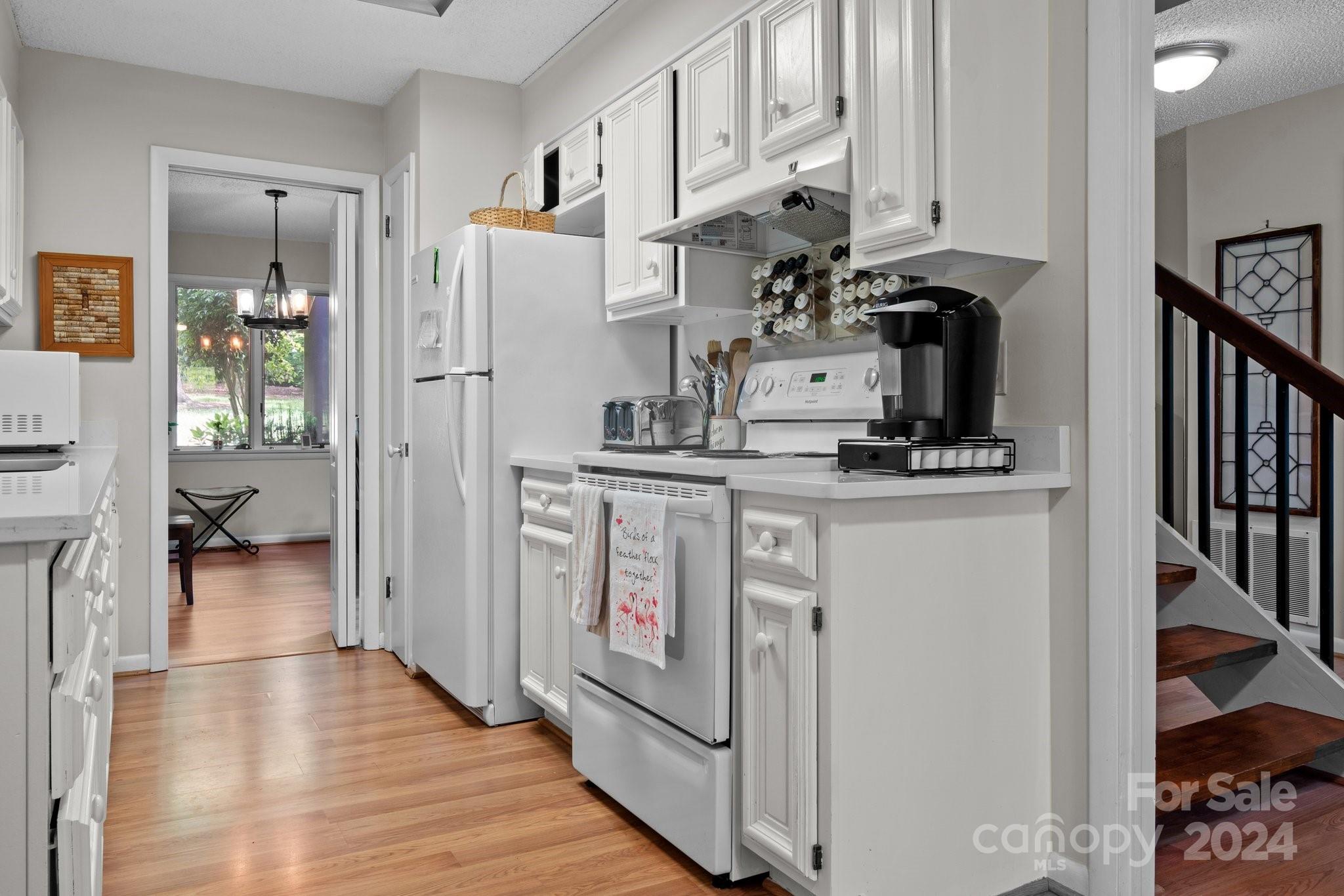 103 Crowfields Drive Asheville, NC 28803 - Photo 7 of 29 a kitchen with stainless steel appliances granite countertop a stove and a refrigerator