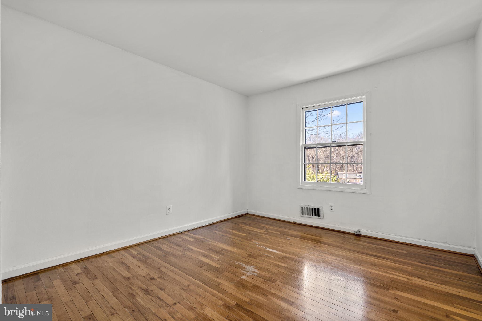 5927 Bayshire Road, Unit 115 Springfield, VA 22152 - Photo 21 of 55 an empty room with wooden floor and windows