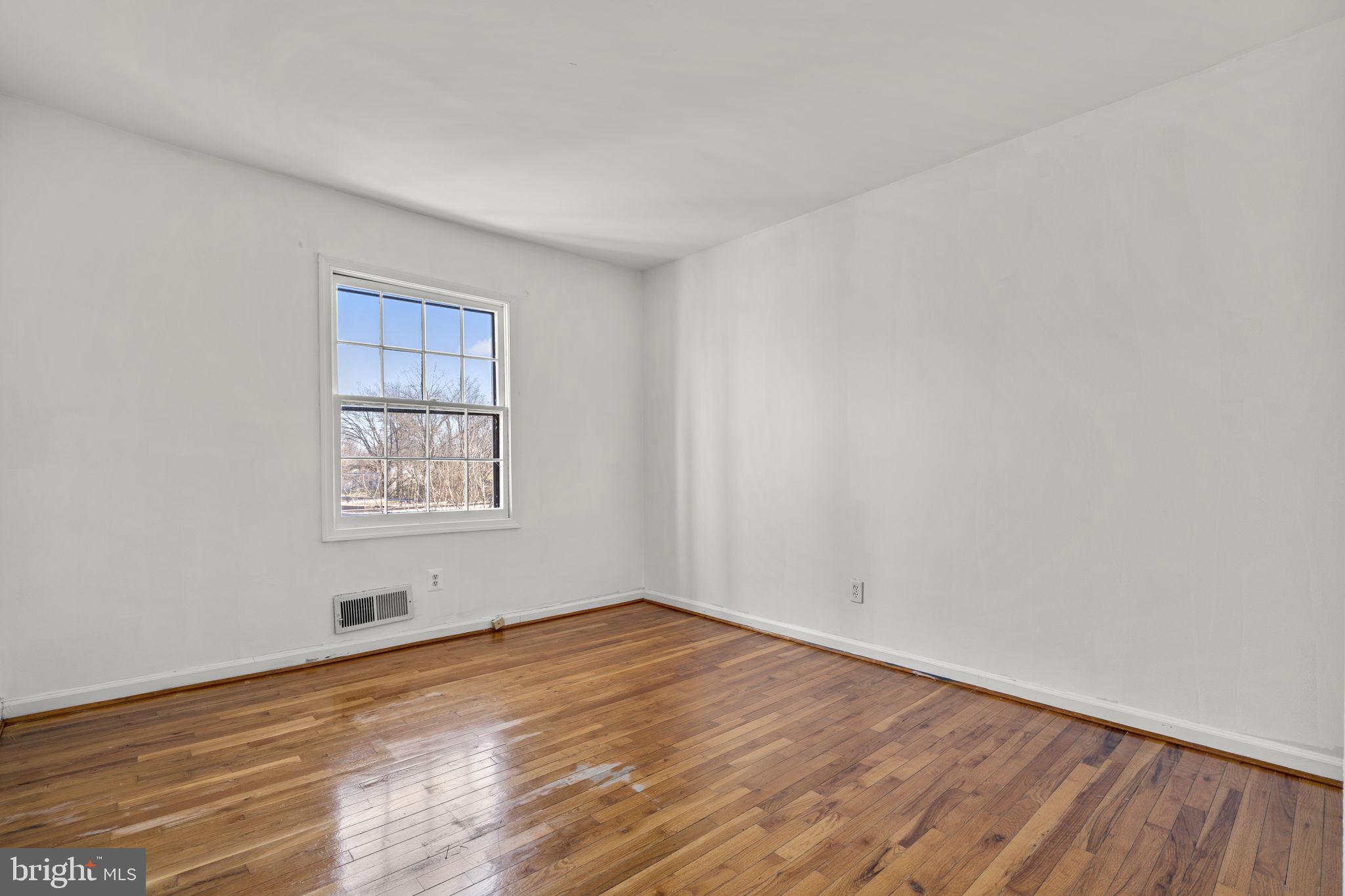 5927 Bayshire Road, Unit 115 Springfield, VA 22152 - Photo 22 of 55 an empty room with wooden floor and windows