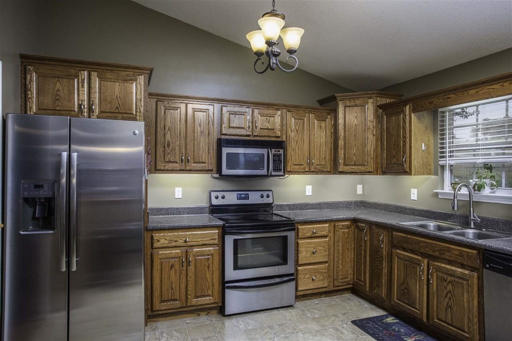 920 Grassy Branch Road Dayton, TN 37321 - Photo 4 of 21 a kitchen with a sink stainless steel appliances cabinets and a window