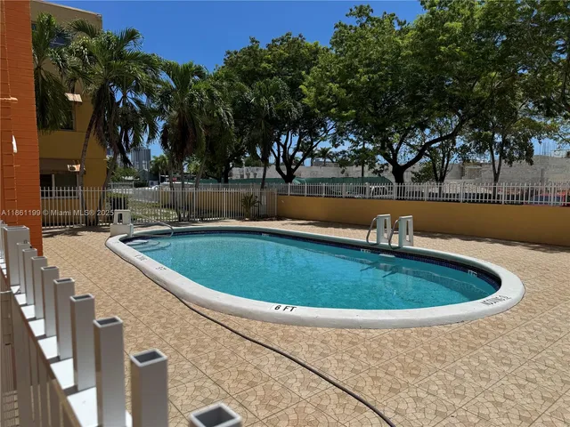 a view of a swimming pool with an outdoor space and seating area