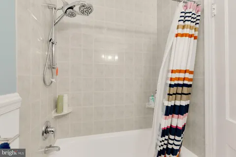 a bathroom with a bathtub and shower