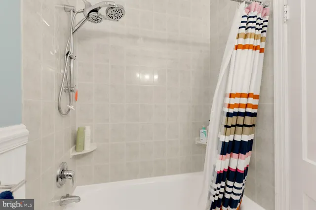 a bathroom with a bathtub and shower