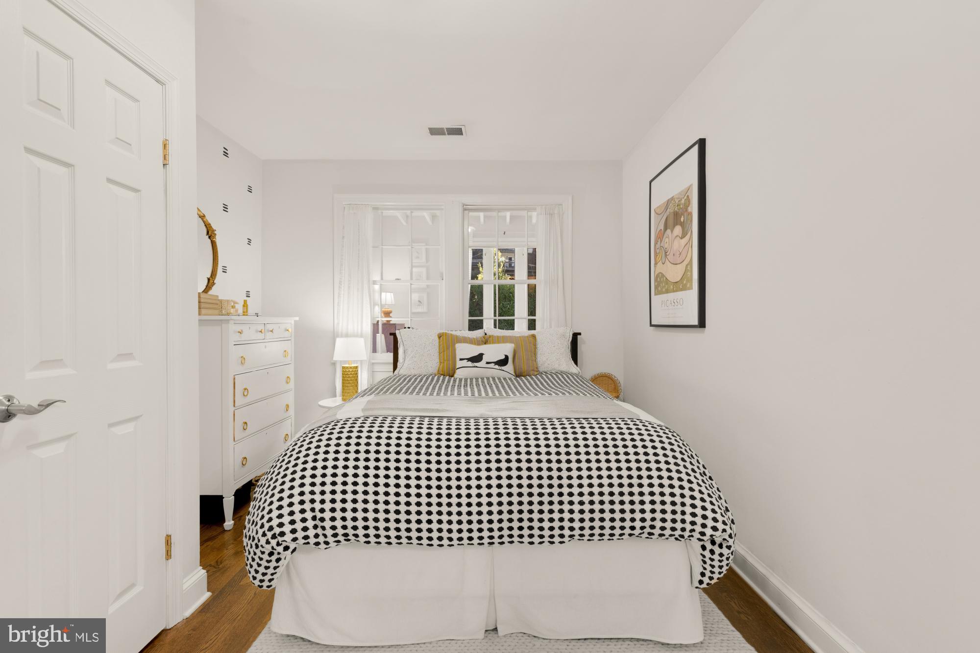 2650 39th Street Northwest, Unit 3 Washington, DC 20007 - Photo 13 of 27 a bedroom with a bed and wooden floor