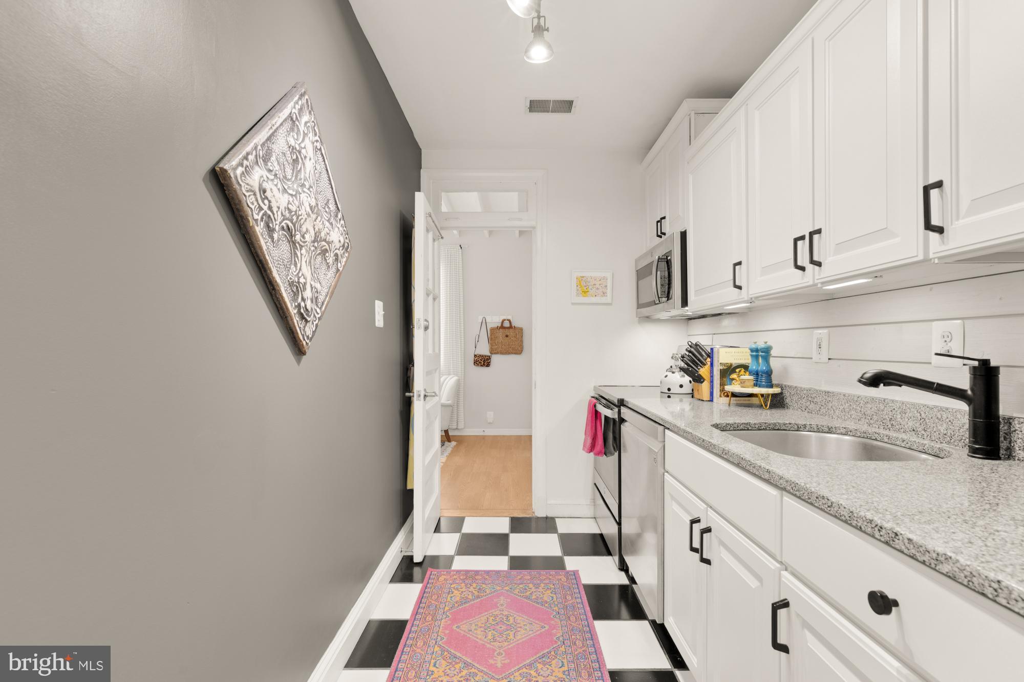 2650 39th Street Northwest, Unit 3 Washington, DC 20007 - Photo 16 of 27 a kitchen with a sink a stove and cabinets