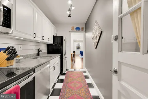 a kitchen with stainless steel appliances a stove a microwave sink and cabinets