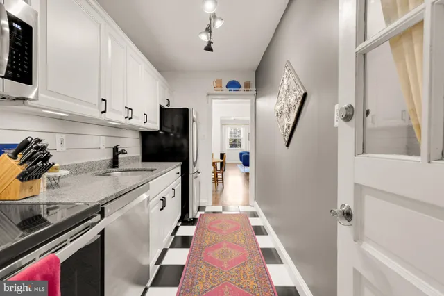 a kitchen with stainless steel appliances a stove a microwave sink and cabinets