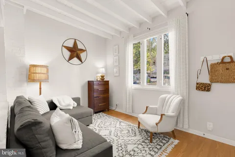 a living room with furniture and a lamp