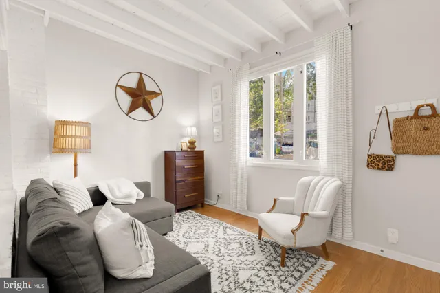 a living room with furniture and a lamp