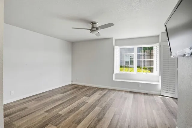 wooden floor in an empty room with a window