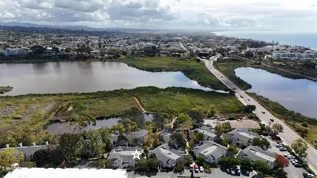 an aerial view of residential houses with outdoor space and river