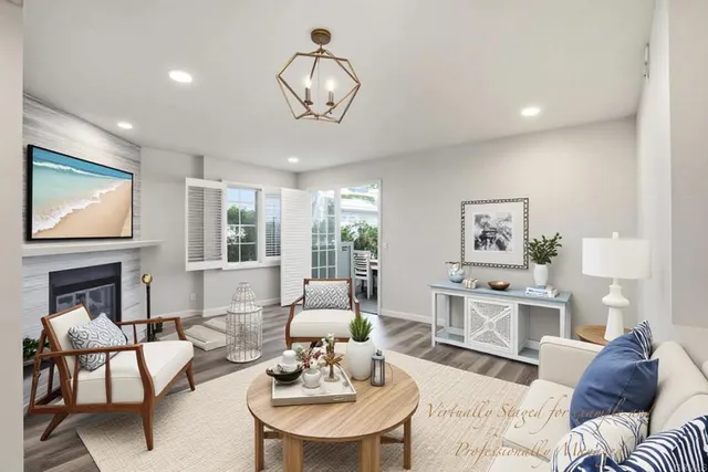 a living room with furniture fireplace and a large window