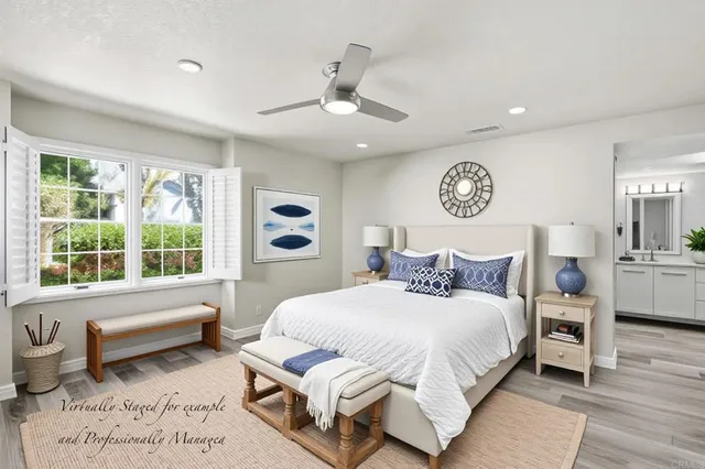 a bedroom with a bed and a large window