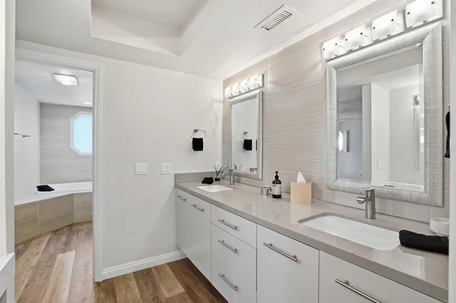 a bathroom with a double vanity sink and mirror
