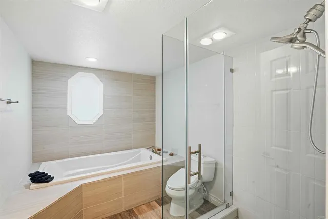 a bathroom with a tub a sink and a shower