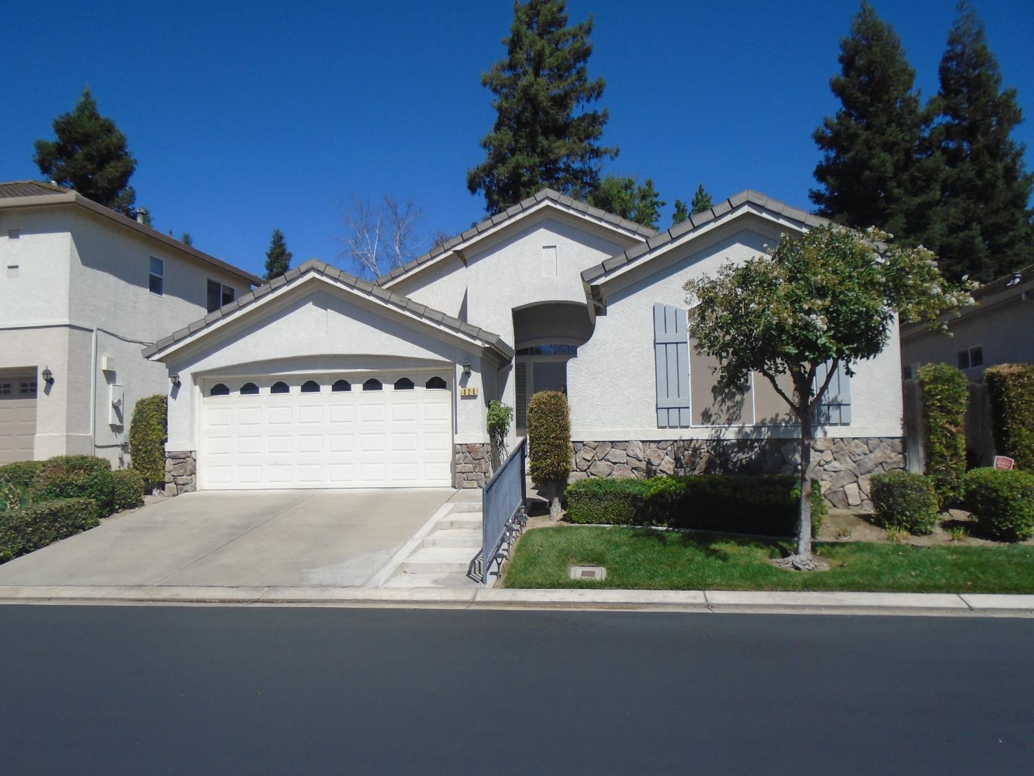 a view of a house with a yard and garage
