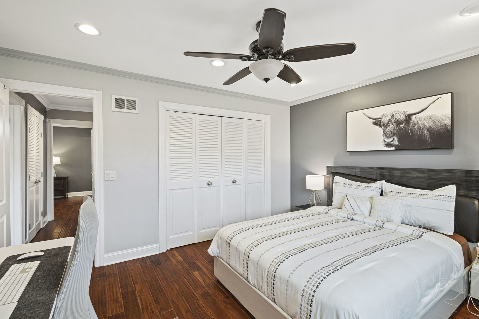 1600 Birch Street Park Ridge, IL 60068 - Photo 19 of 34 a bedroom with a large bed and a chandelier