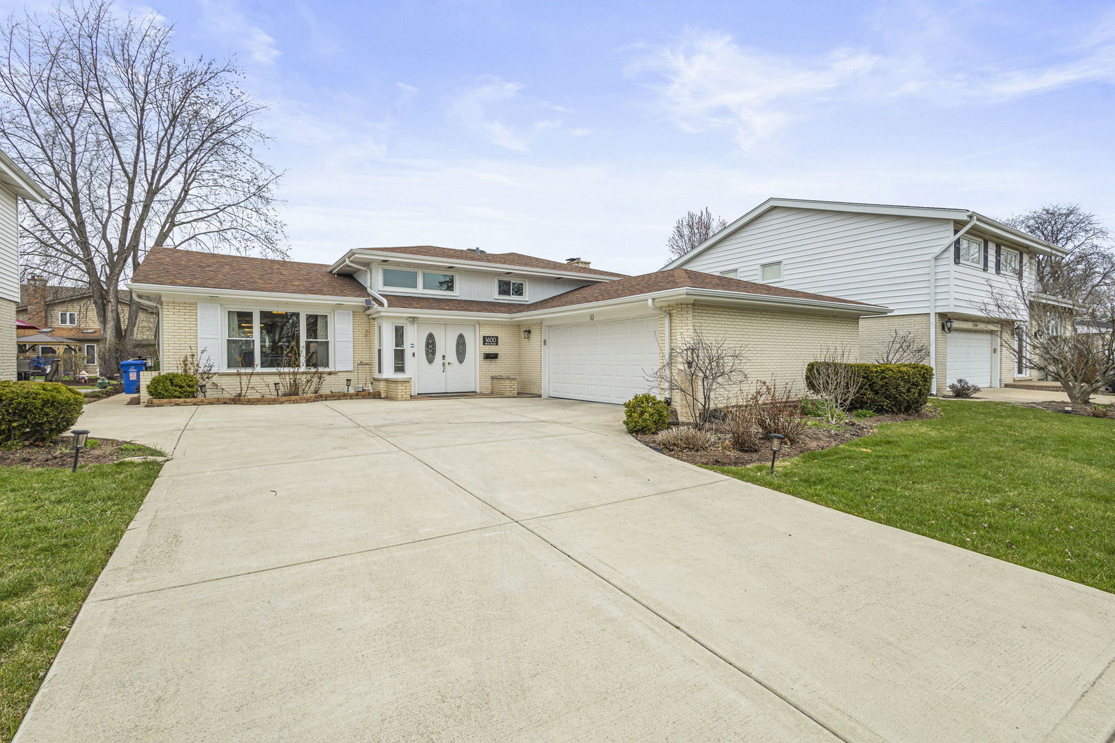 1600 Birch Street Park Ridge, IL 60068 - Photo 2 of 34 a front view of a house with a garden and plants