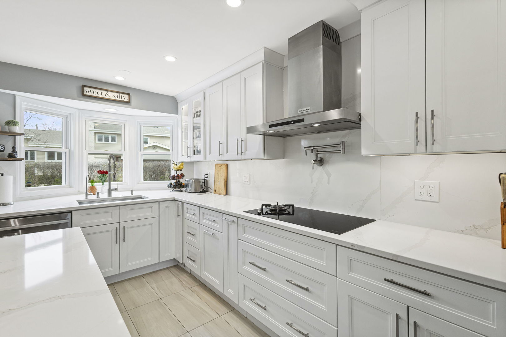 1600 Birch Street Park Ridge, IL 60068 - Photo 7 of 34 a kitchen with white cabinets and sink