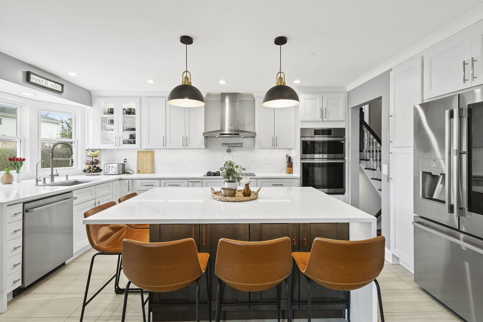 1600 Birch Street Park Ridge, IL 60068 - Photo 9 of 34 a kitchen with stainless steel appliances a dining table chairs and refrigerator