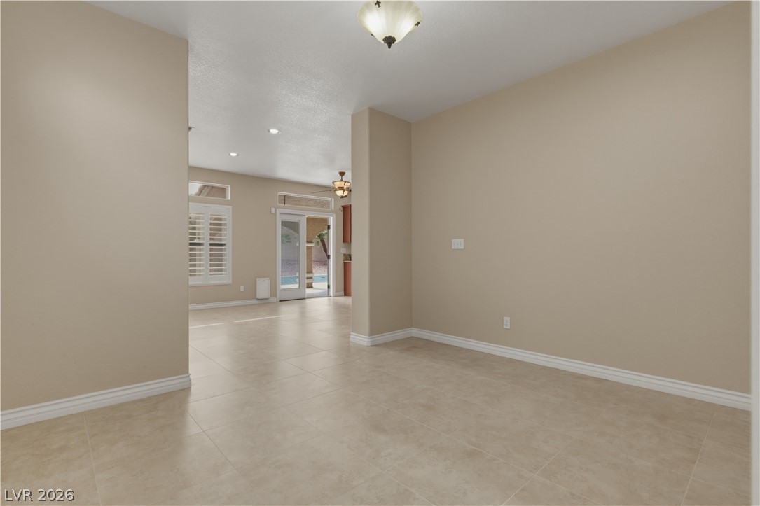 29 Olive Tree Henderson, NV 89074 - Photo 23 of 60 This bright, open space features sleek tiled flooring and sliding glass doors leading to the outdoors.
