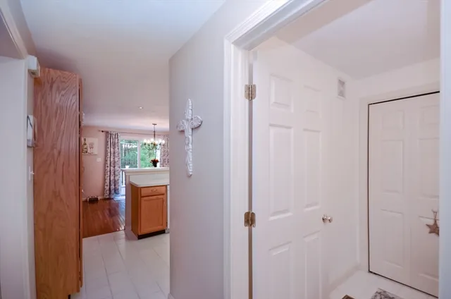 a view of a hallway with bathroom and front door