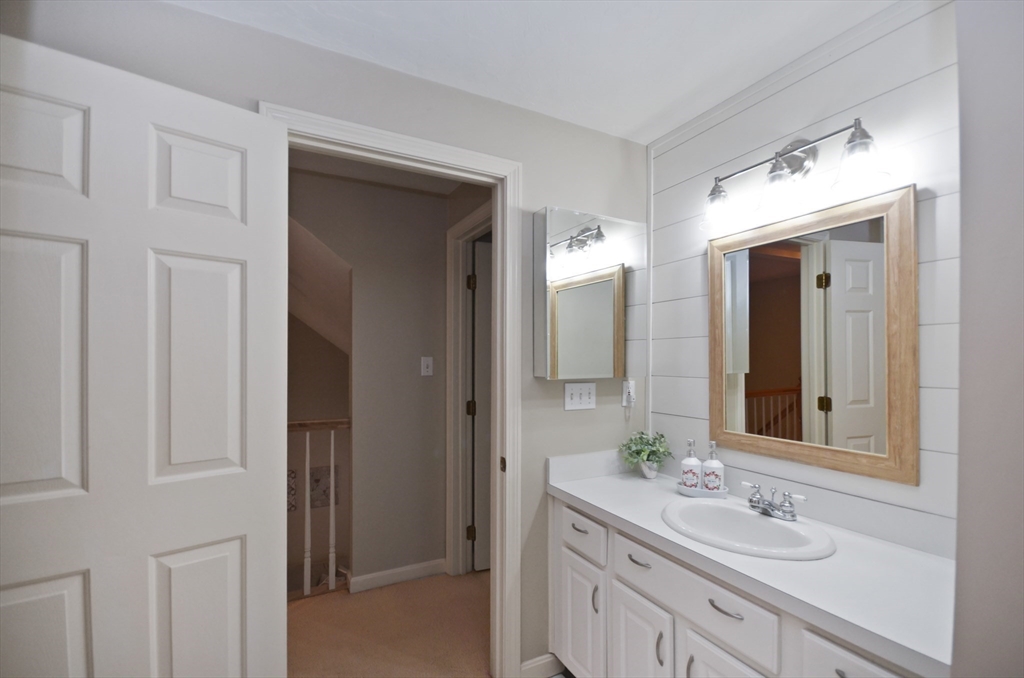 20 Millers Way, Unit C Sutton, MA 01590 - Photo 22 of 41 a bathroom with a sink and a mirror
