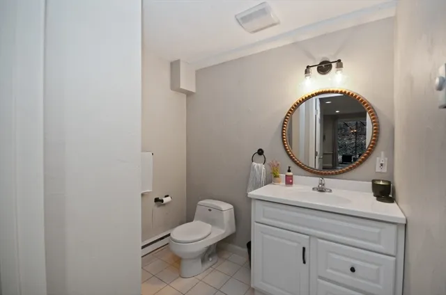 a bathroom with a toilet a sink and mirror