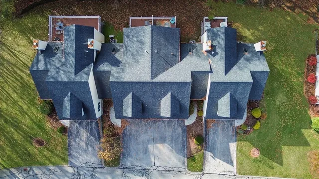 an aerial view of residential houses with outdoor space