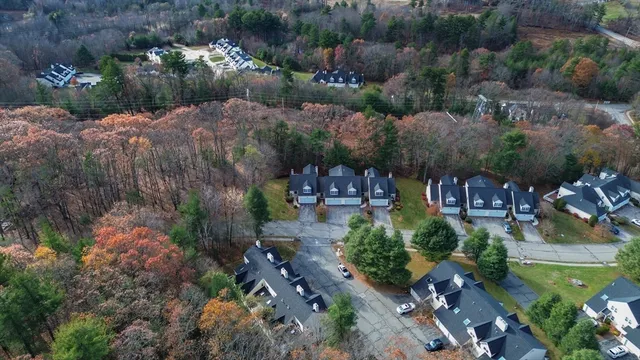 an aerial view of a house with a yard and lake view