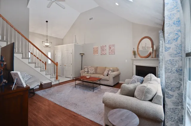 a living room with furniture and a chandelier