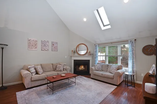 a living room with furniture flat screen tv and a fireplace