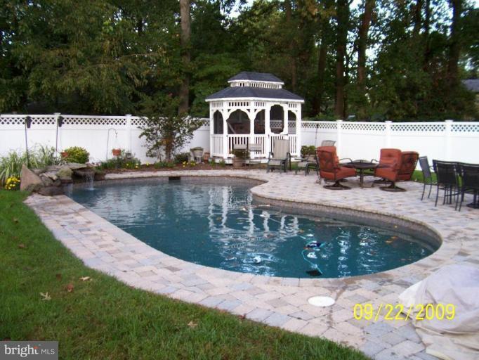 Custom built in pool with gazebo and privacy fence